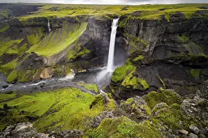 River and waterfalls at a canyon with green moss