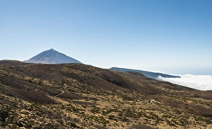 Road leading through a volcanic landscape with Pico del Teide