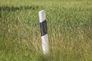 Road marker post on a country road