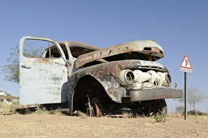 Road sign, Dead Slow, alongside a wrecked car