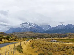 Road and yellow grasslands to Torres del Paine National Park