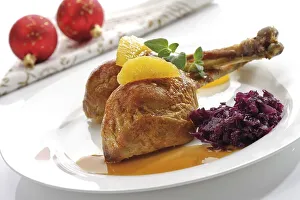 Roast chicken legs or drumsticks garnished with two orange segments