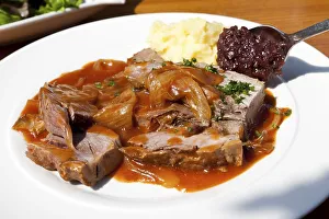 Roast pork with onion sauce, mashed potatoes and red cabbage