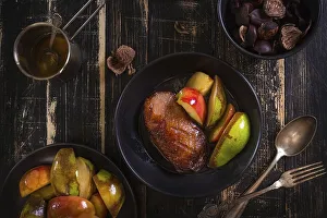 Roasted duck breast with golden crispy skin served with baked apples and chestnuts