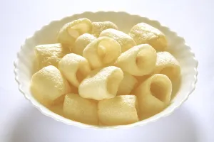 Roasted round chips in bowl on white background