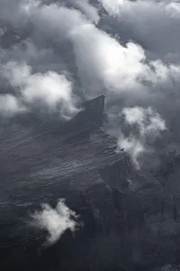 Rocks in fog, mountain landscape with dramatic clouds