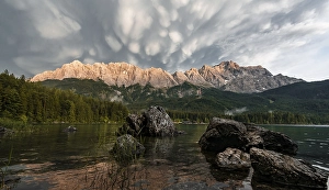 Rocks on the shore, Eibsee lake in front of Zugspitze massif with Zugspitze