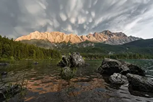 Rocks on the shore, Eibsee lake in front of Zugspitze massif with Zugspitze