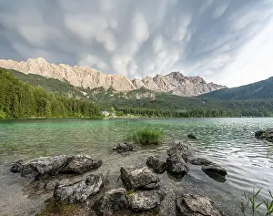 Rocks on the shore, Lake Eibsee lake in front of Zugspitze massif with Zugspitze