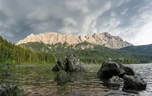 Rocks on the shore, Lake Eibsee lake in front of Zugspitze massif with Zugspitze