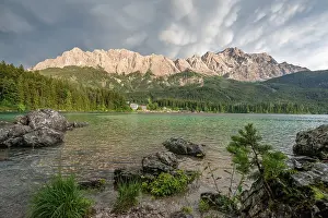 Rocks on the shore, Lake Eibsee lake in front of Zugspitze massif with Zugspitze
