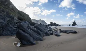 Rocky coast and sandy beach at Praia da Adraga