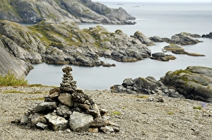 Rocky coastal landscape with pile of stones near Nusfjord Flakstadoya Lofoten Norway