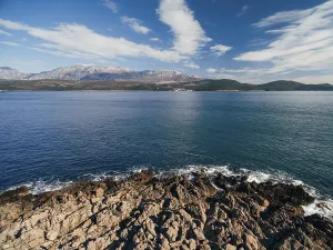 Rocky coastline on the Lustica peninsula overlooking Mount Lovcen in Montenegro