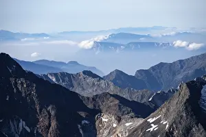 Rocky mountain landscape with snow-capped peaks and clear views
