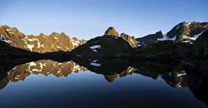 Rocky mountain peaks reflected in a small pond