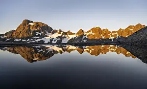 Rocky mountain peaks reflected in a small pond