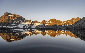Rocky mountain peaks reflected in a small pond