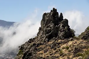 Rocky peak surrounded by clouds