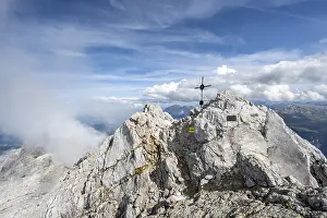 Rocky summit of the Watzmann Mittelspitze with summit cross