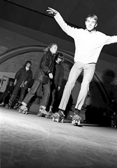 Roller skate fun in the 1960s. Interior of a roller disco with people roller skating