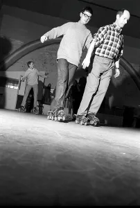 Roller skate fun in the 1960s. Interior of a roller disco with people roller skating
