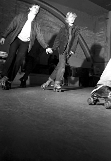 Roller skate fun in the 1960s. Interior of a roller disco with people roller skating
