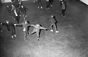Roller skate fun in the 1960s. Interior of a roller disco with people roller skating