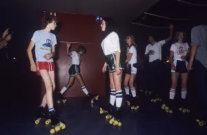 Roller skate fun in the 1970s. Interior of a roller disco with people roller skating