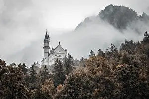 The romantic Neuschwanstein Castle in the middle of a misty