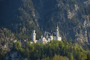 Romantic Neuschwanstein Castle surrounded by forests and mountains