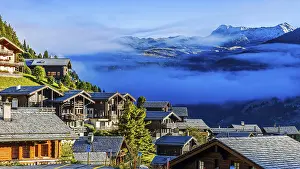 Roofs covered with hoarfrost, fog rising
