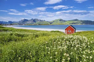 Rorbuer, traditional wooden house on sandy beach Rambergstranda