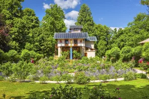 Rosarium with blooming roses in front of the Pompeian-Bavarian Casino on the Rose Island in Lake Starnberg