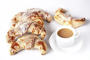 Rosy croissants and coffee with milk