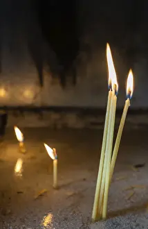 Row of burning memorial candles in the chapel of the orthodox monastery in Meteora