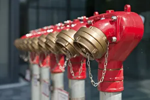 A row of extinguishing water connections in front of an office building
