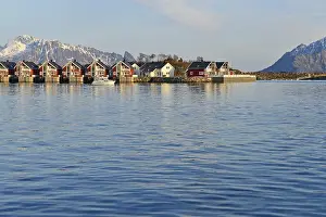 Row of red cottages by the blue water