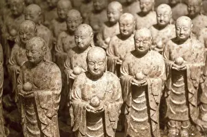 Rows of similar Japanese Jizo sculptures