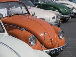 Rows of vintage cars with an orange car in the foreground