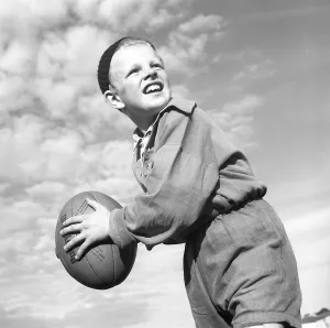 Rugby 1940. A young rugby player is holding the rugby ball, looking for someone to throw it to. The rugby ball has an oval shape, four panels and a weight of about 400 grams. 1942. Kristoffersson ref A56-4