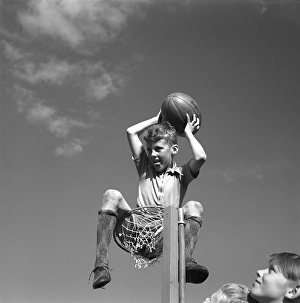 Rugby 1940. A young rugby player is holding the rugby ball in his hands