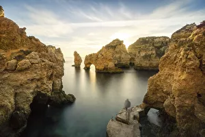 Rugged rocky coast, cliffs and arches in Ponta da Piedade at sunrise