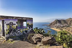 Ruin with graffiti, view of the sandy beach Playa de Las Teresitas