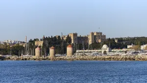Ruins and windmills along a picturesque coastline