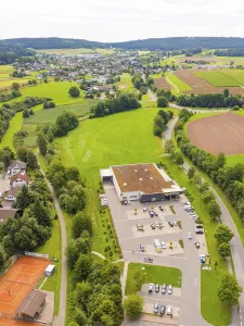 Rural landscape with a large car park and surrounding fields and roads