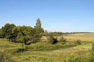 Rural landscape with a small river and sloping field