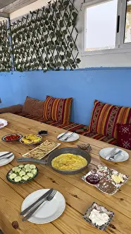 Rustic wooden table features a spread of moroccan breakfast food