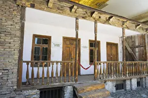 Rustic wooden veranda of a building with old wooden windows