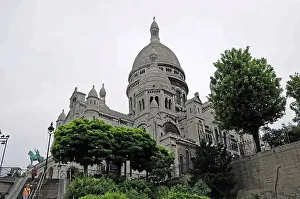 The Sacre-Cœur Basilica on the Montmartre hill surrounded by trees